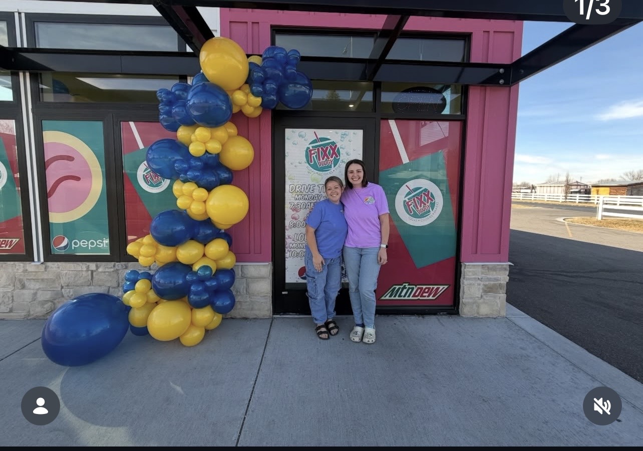 Blue and yellow balloon garland at a shop grand opening